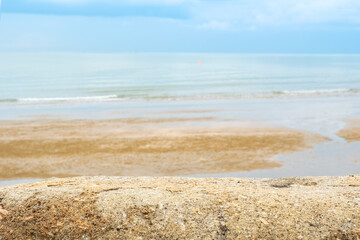 Stone floor counter top There is a view of sea in the background of the resort. A blurry beach and...