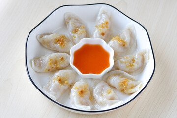 Close up of Choi Pan, a traditional Chinese dumpling popular in Pontianak, West Kalimantan. These steamed dumplings are filled with jicama (bengkuang) and served with fried garlic and chili sambal.