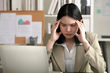 Young Asian Businesswoman looking stressed from work, Young businesswoman working at office feels overworked and burnout, Healthcare office syndrome concept