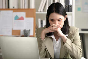 Young Asian Businesswoman looking stressed from work, Young businesswoman working at office feels overworked and burnout, Healthcare office syndrome concept