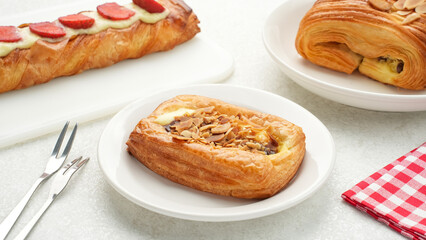 Assorted freshly baked pastries on white background