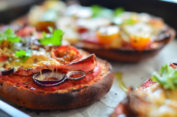Close-up of a freshly baked zapiekanka baguette topped with vegetables, tomatoes, and fresh herbs, showcasing vibrant colors and appetizing textures, perfect for food, culinary, and gourmet projects