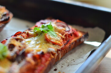 Close-up of a freshly baked zapiekanka baguette topped with vegetables, tomatoes, and fresh herbs, showcasing vibrant colors and appetizing textures, perfect for food, culinary, and gourmet projects