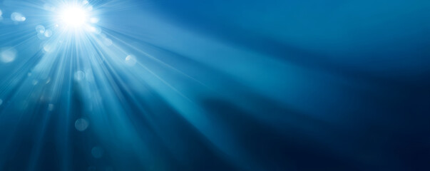 Sunlight rays underwater with blue bokeh and serene glow creating peaceful mood