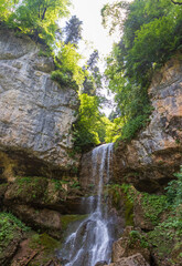 Obraz premium waterfall on a mountain river, natural flow of water from rocky ground, state of nature