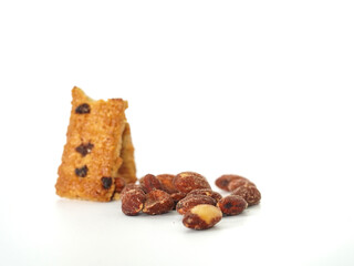 Close up Protein Bar and Almonds bean on white background. Food for energy breakfast, brunch snack, and crackers. Healthy food contains antioxidants nutrients protein, vitamins. Grains nutrition 