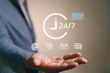Businessman offering 24/7 customer service and support. The virtual interface shows contact us icons for email, phone call, and chat, representing a non-stop online helpdesk solution.