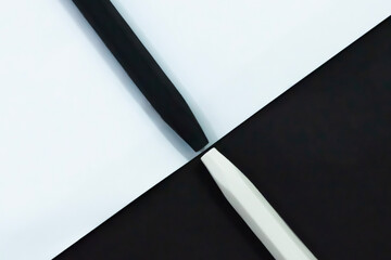 Contrasting Black and White Pens Meeting at Diagonal Divide