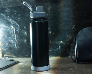 Matte Black Insulated Water Bottle on Dark Wood Background