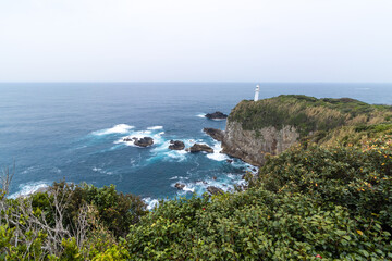 View of Cape Ashizuri and lighthouse on cliff with blue ocean and skyline background