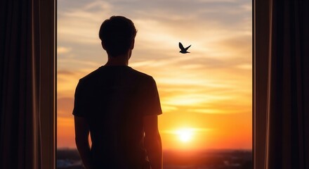 Man silhouette watching a bird fly into the golden sunset from a window