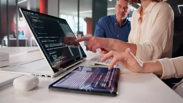 Team Developing Code On Laptop And Tablets