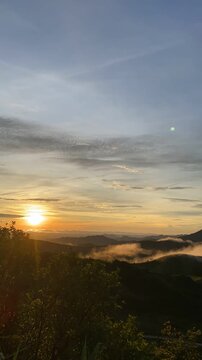 Serene Landscape with Rolling Hills and Fog in Early Morning Light sunset pilok thailand