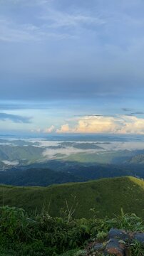 Lush Green Hills and Serene Clouds Over Rolling Landscape Horizon pilok thailand