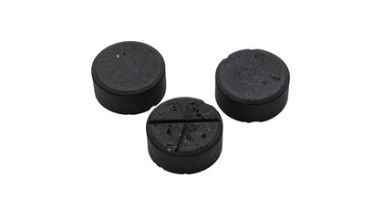 Three black round pills on black