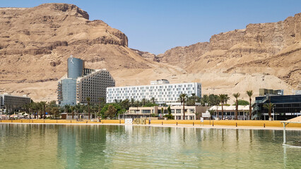 Hotels on the shores of the Dead Sea against the backdrop of desert mountains