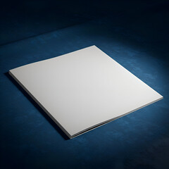 Blank magazine lying on a textured dark blue surface. Empty publication showcasing design possibilities.