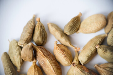Organic dried green cardamom pods isolated on a white background