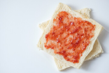 Close-up of white bread with raspberry jam