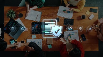 A diverse business team engages in a collaborative discussion focused on data security strategies, enhanced by digital graphics representing analysis and protection. Raster - Powered by Adobe