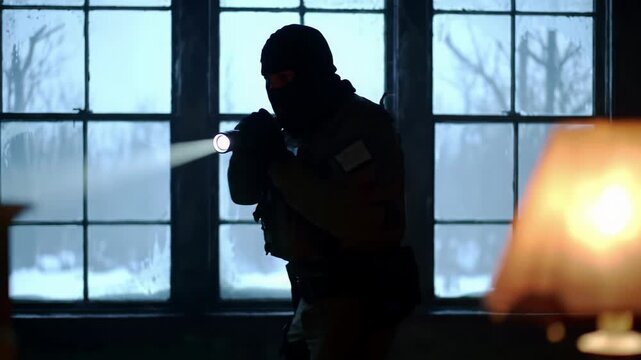 Wary person in balaclava sweeps flashlight in a dim room with blurred lamp and desolate snowy window view. Suspenseful home security threat video