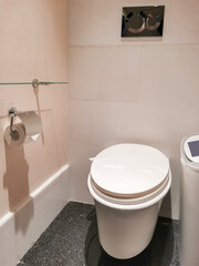 Minimalist bathroom interior showcasing a toilet with closed lid and basic amenities with clean