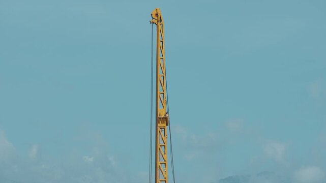 Pile-driving (copra) part of the excavator. Pile driving works at the construction site. Modern hydraulic lifting mechanisms.