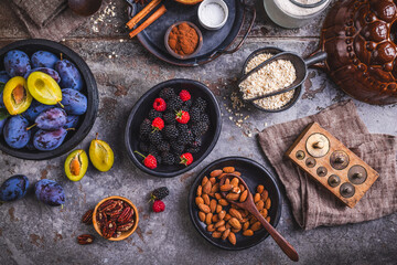 Freshly picked berries and plums with healthy baking ingredients