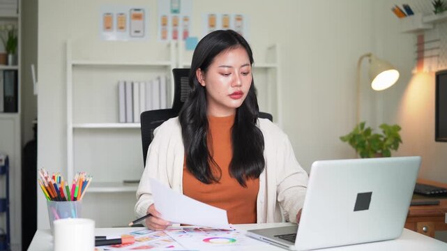 Creative female developer engaged in UX UI project, designing app wireframes and digital product workflow.