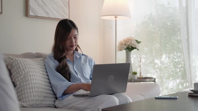 Relaxed woman enjoying work from home lifestyle with modern technology