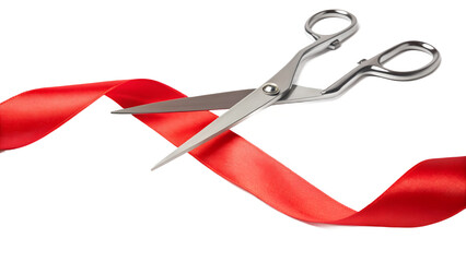 A pair of scissors cutting a red ribbon on a white background close up