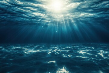 Obraz premium Underwater rays illuminating a tranquil ocean surface during midday