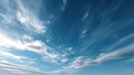 A vast expanse of blue sky adorned with wispy clouds, creating a serene and tranquil atmosphere.