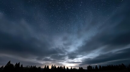 A stunning night sky filled with stars, illuminated by a soft glow on the horizon, surrounded by dark clouds and silhouettes of trees.