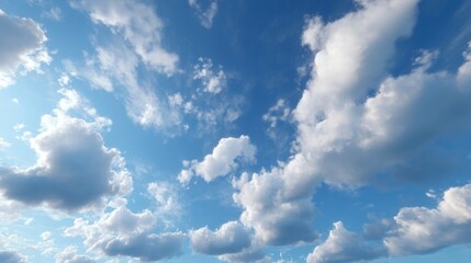 A serene sky filled with fluffy white clouds against a bright blue backdrop, creating a peaceful and expansive atmosphere.