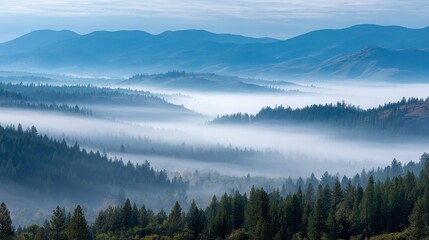 A serene landscape showing layered mountains shrouded in mist and lush green forests, creating a tranquil and atmospheric scene.