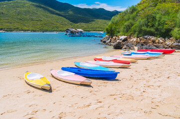 Kayaks on the sandy beach by the sea in the blue lagoon in summer on vacation on a sunny day
