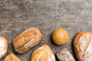 Homemade natural breads. Different kinds of fresh bread as background, top view with copy space