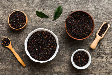 quinoa seeds in bowl and spoon on colored background. Healthy kinwa in small bowl. Healthy superfood