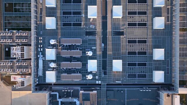 Modern data center building roof with telecommunication antennas, HVAC units, server facility, Warsaw, Revealing drone shot