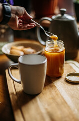 Pouring honey into a cup