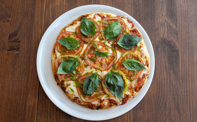 Pizza margherita with fresh tomatoes, basil, and pesto