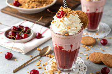 Creamy milkshake topped with cherry, whipped cream, and crunchy