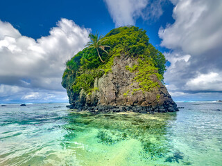 Turquoise waters, shallow coral reefs teaming with tropical fishes, off shore rock formations inhabited by roosters of Flying foxes, Route 001, Tutuila Island, American Samoa