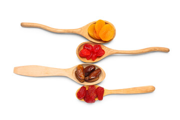 Wooden spoons with different candied fruits on white background