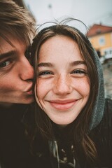 Teenage girlfriend and boyfriend have fun outdoors, kissing and hugging, first