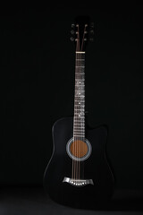 Obraz premium Acoustic guitar on black background