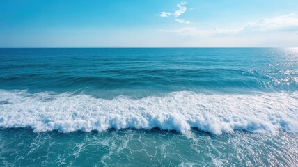 Fototapeta premium Aerial view of calm ocean, deep blue water perfect for a relaxing experience.