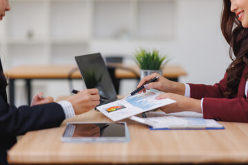 Business women discussing financial data during meeting
