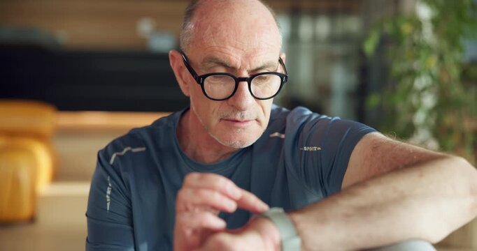 Athlete, senior man and check watch for fitness app, track performance and workout results. Elderly person, wristwatch and monitor for heart rate, exercise progress and time for health stats at house